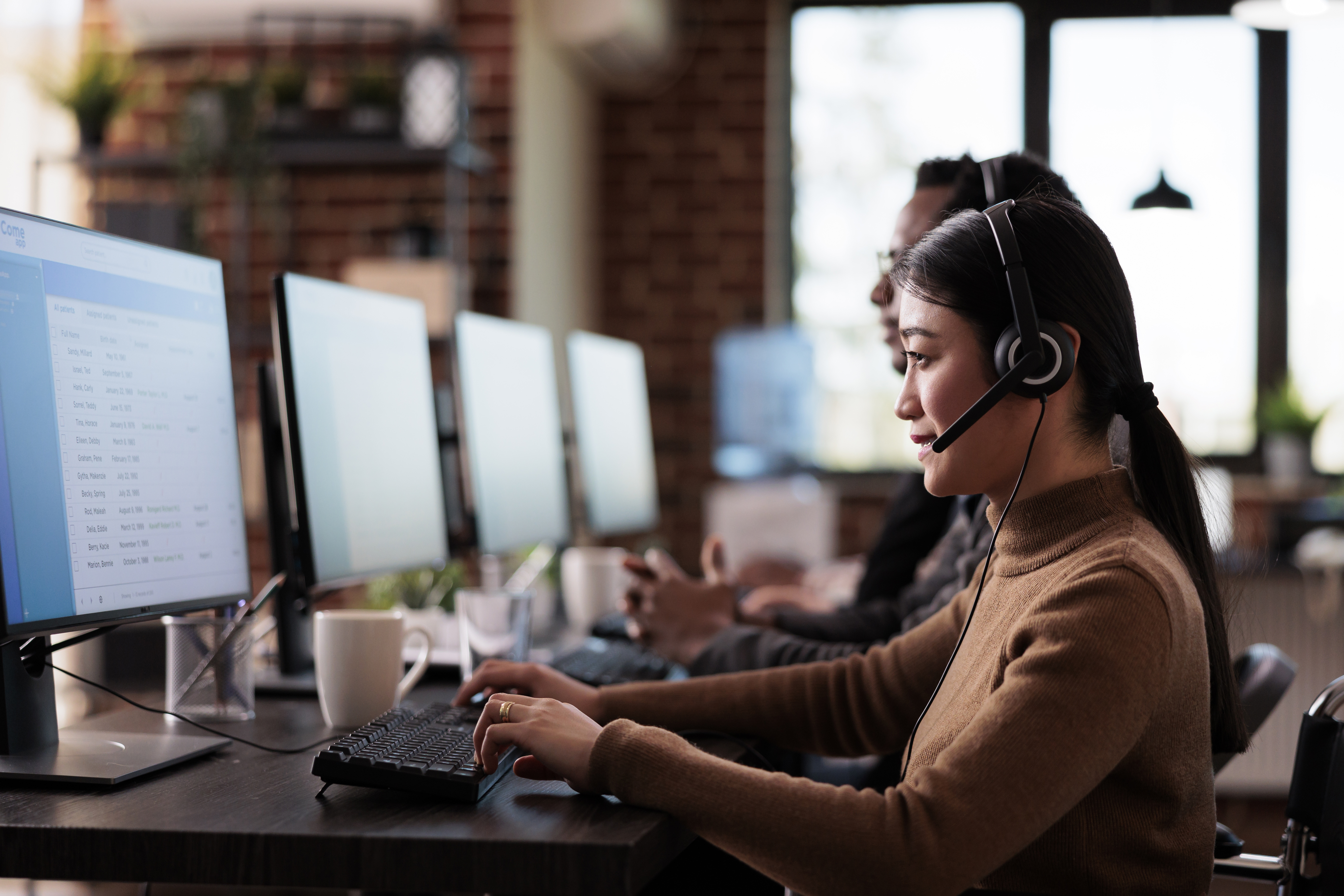 paralyzed-asian-employee-working-call-center-reception-disability-friendly-office-female-operator-wheelchair-user-with-impairment-giving-assistance-customer-service-helpline